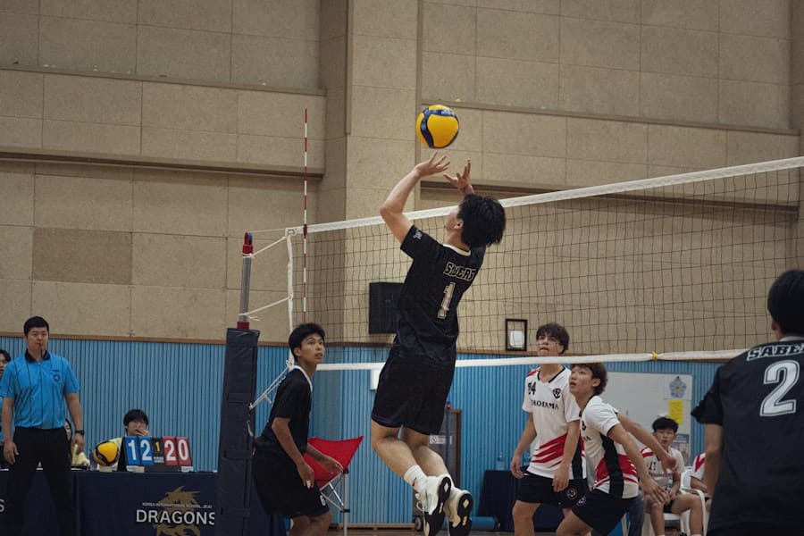 Athletes competing in an indoor volleyball match