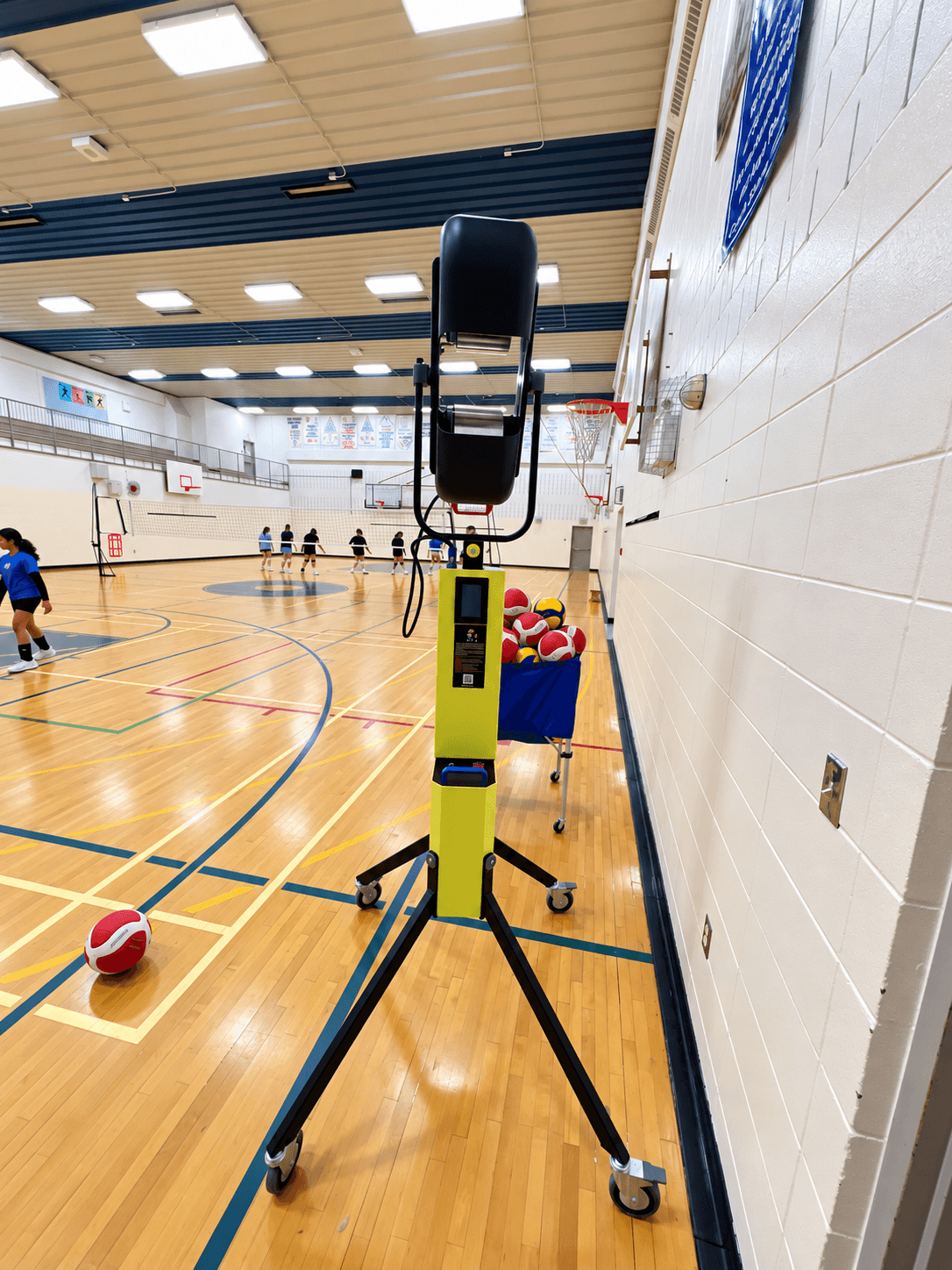 Volleyball equipment and athletes preparing on an indoor court